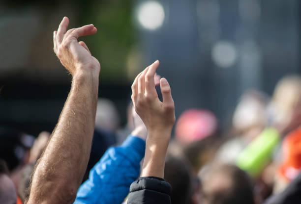 istock hands up at an outdoor music event 1178409747
