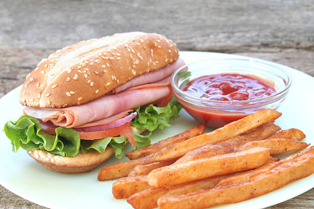 Club Sandwich cut into triangles with fries.