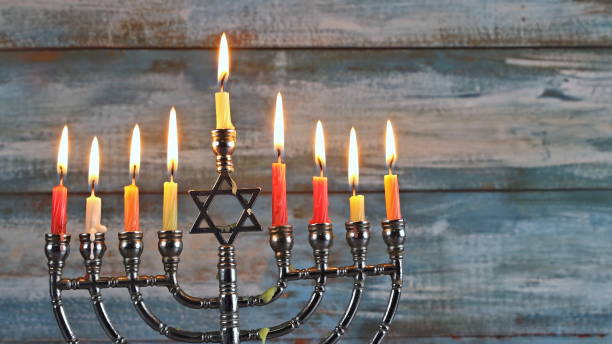 istock Menorah with candles for Hanukkah against defocused lights 1178420914