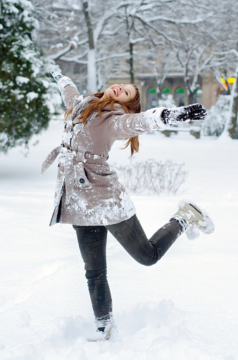 Smiling woman carrying snowboard
