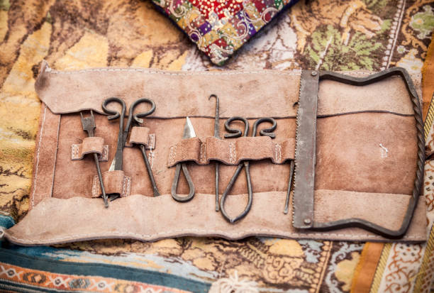 Medieval surgery doctors tools in leather wrap Medieval surgery doctors tools in leather wrap. Campaign surgical equipment leather care stock pictures, royalty-free photos & images