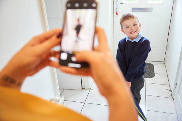 First day at school picture for smiling toddler Smiling toddler ready for his first day at school having his picture taken front door photos stock pictures, royalty-free photos & images