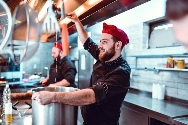 Male Cook Happy With The Soup He's Making