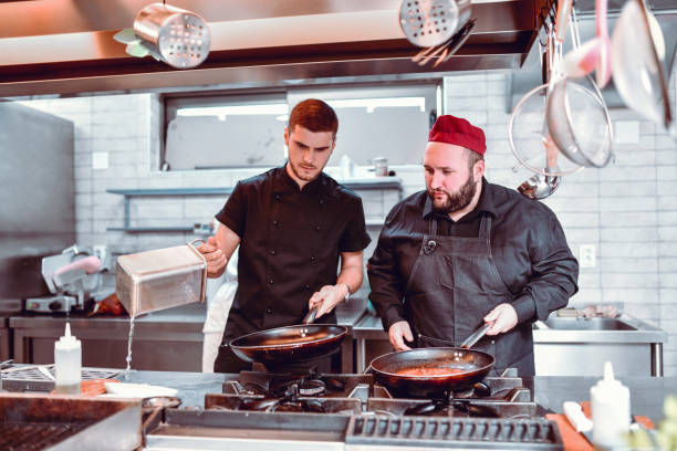 istock Two Chefs Making Sauce And Frying Meat 1178425851