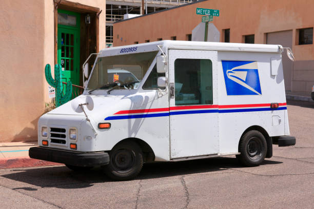 USPS Grumman mail vehicle in downtown Tucson AZ stock photo
