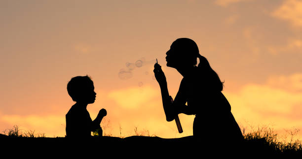 istock Mother and her little son blowing bubbles 1178433104