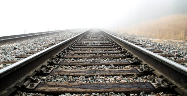 Railroad Tracks in the Clouds Railroad tracks high in the Colorado Rocky Mountains travel through thick clouds. railway track stock pictures, royalty-free photos & images