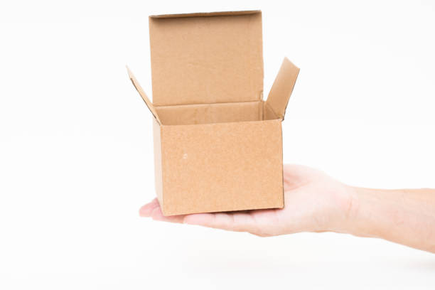 istock Man hand holding brown paper box on white background 1178448155