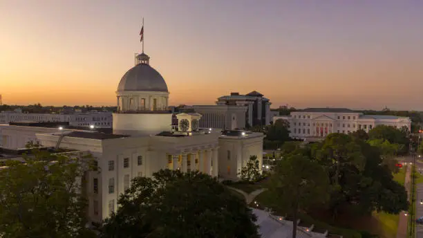 Golden sunlight reaches the horizon showing around the capital statehoue in Montgomery Alabama