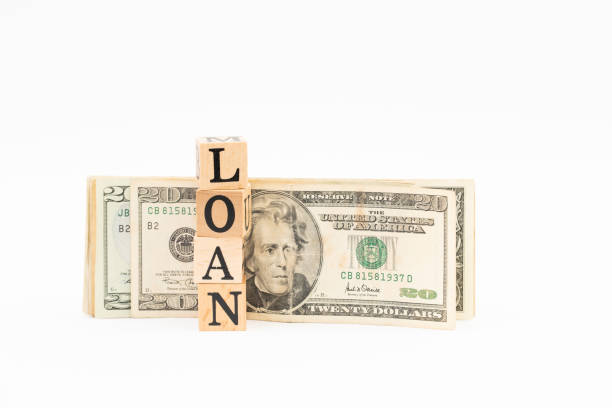 istock Wood block loan word with dollar banknote on white background. 1178450382