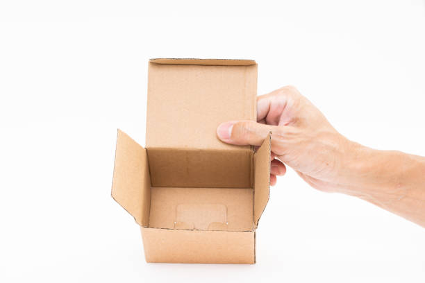 istock Man hand holding brown paper box on white background 1178450474