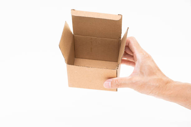 istock Man hand holding brown paper box on white background 1178450501