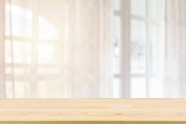 istock Empty wood table top with window curtain abstract blur background for product display 1178451346