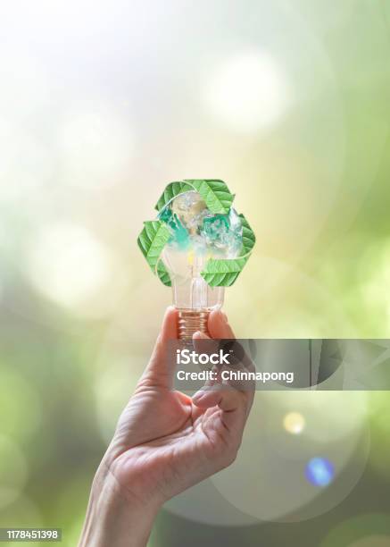 Ecology Energy Saving Renewable Waste Management And Sustainable Development Concept With Lightbulb With Recycle Leaves Environmental Protection Symbol In People Hand Stock Photo - Download Image Now