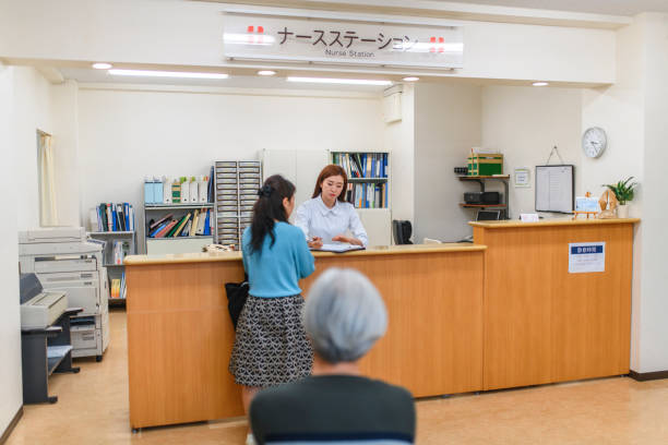 istock Japanese Nurse Helping Patient at Nurses Station Counter 1178451412