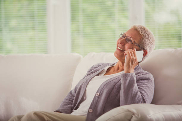 istock Cheerful senior woman using her mobile phone and smiling 1178451724