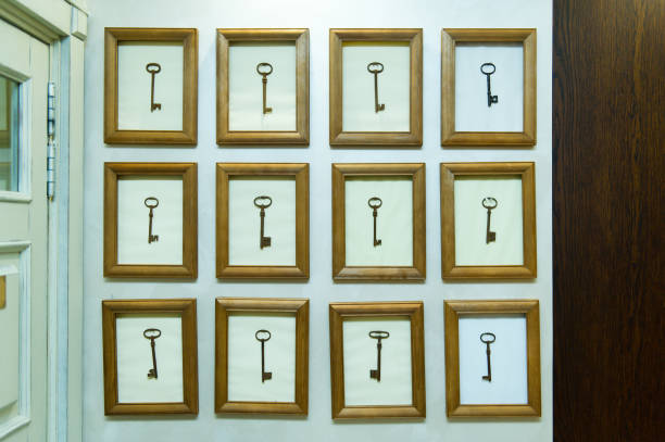 wooden frames hang on the wall near the door, inside each is an old big key