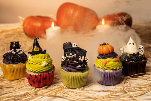 istock Halloween sweets , cupcakes in Halloween theme, real smoke in background 1178458295