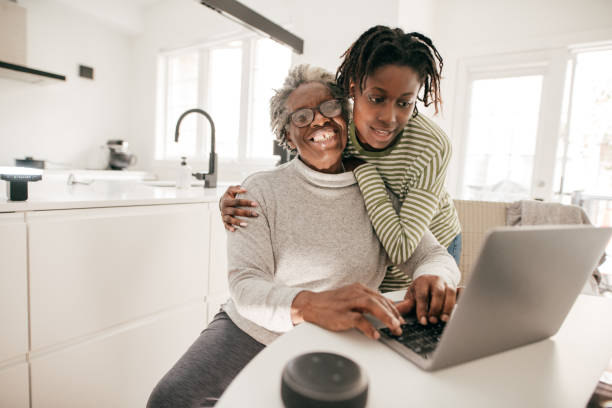 istock Grandma and granddaughter using laptop in the kitchen 1178458694