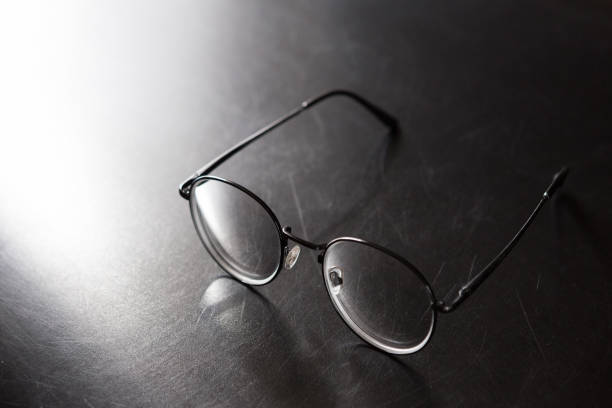 istock Selective focus of glasses on black background and copy space with light and shadow 1178460604