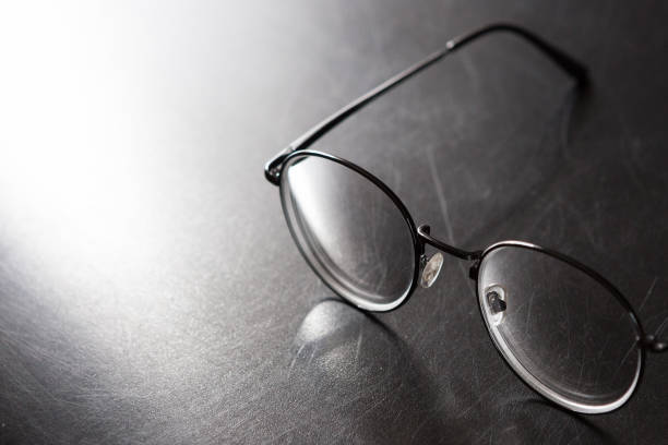 istock Selective focus of glasses on black background and copy space with light and shadow 1178460640