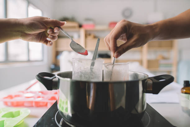 istock 2 asian chinese female and male working on handmade soap making workshop in a studio and mixing the raw material and cooking it 1178463487
