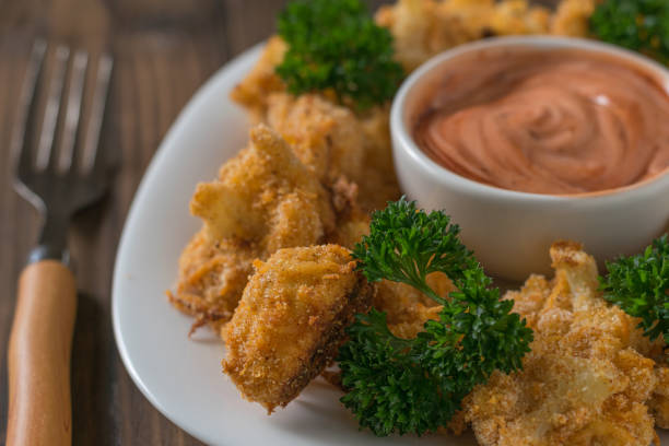 istock Baked cauliflower with the sauce and a fork on the table. 1178467146