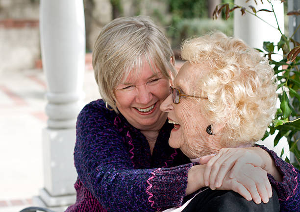 Senior mother and daughter laughing stock photo