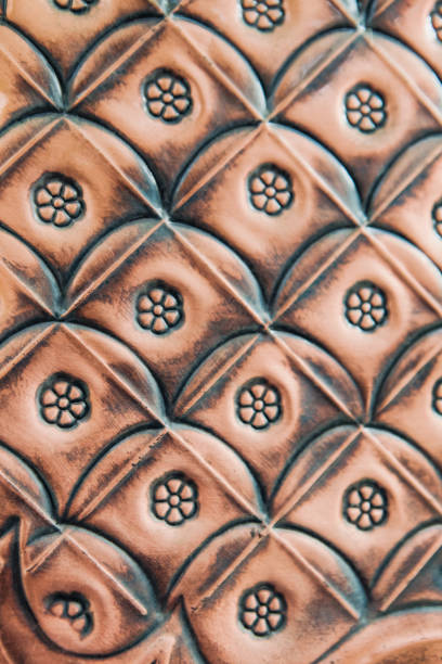 Copper background in neutral light. Thin strip of oxidized copper at the top edge of the photo. Left bottom lighting. Perfect for Design and projects. Copy space.