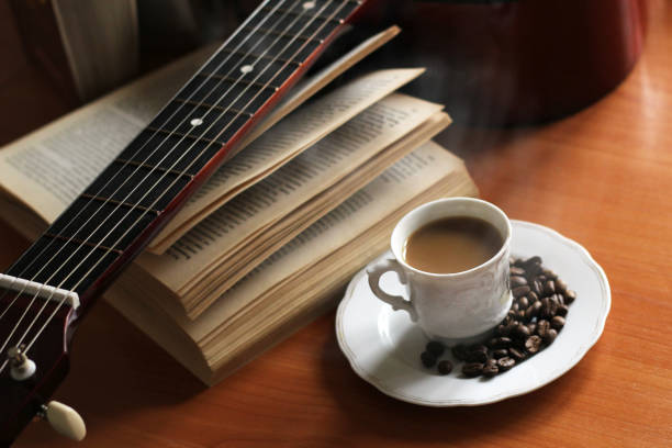 istock Coffee cup and guitar on wooden table 1178487568
