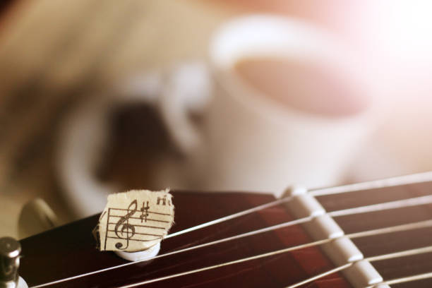 Guitar strings, torn paper notes and a Cup of coffee, music