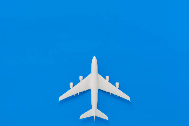 istock Miniature airplane on blue background 1178489960