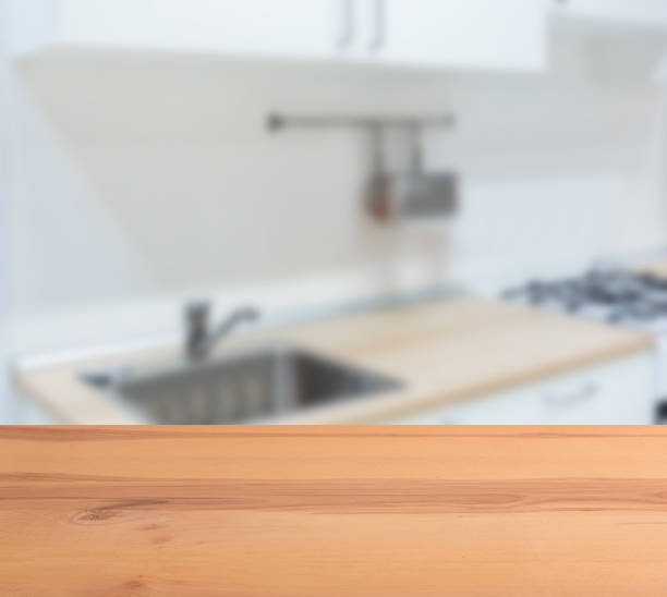 wooden table top and blur kitchen room of the background - domestic kitchen kitchen sink contemporary counter top imagens e fotografias de stock