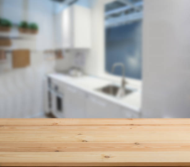 wooden table top and blur kitchen room of the background - domestic kitchen kitchen sink contemporary counter top imagens e fotografias de stock