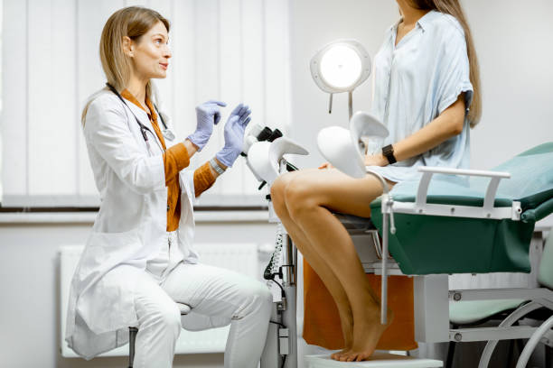 Gynecologist with patient in the office Gynecologist preparing for an examination procedure for a pregnant woman sitting on a gynecological chair in the office gynaecologist stock pictures, royalty-free photos & images