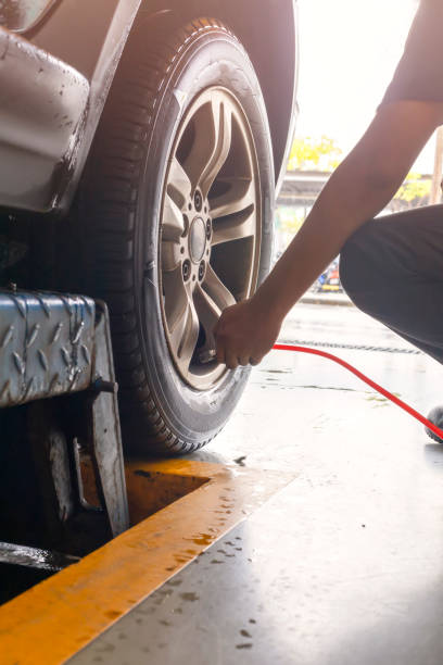 istock Man technician is inflate put air into the tire . car tyre. 1178494036