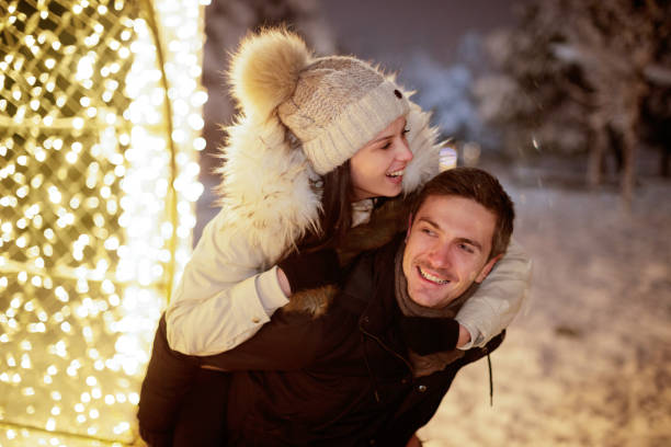 istock Young man carrying his girlfriend on his back with a smile 1178496966