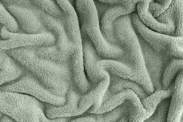 Close up top view of coral blanket wrinkled texture. Fluffy mint tranquil green background. Close up top view of coral blanket wrinkled texture. Fluffy mint tranquil green background. Top view. fluffy blanket stock pictures, royalty-free photos & images