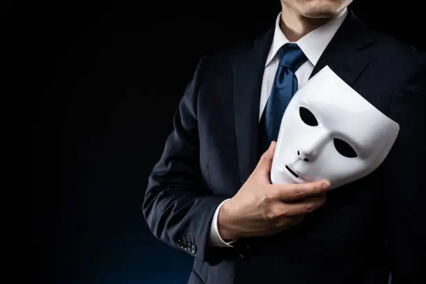 Photo of Man in suit and mask