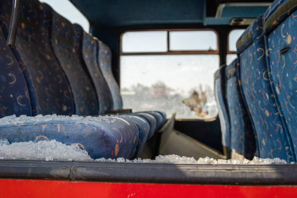 Interior seats with broken windows of the wrecked bus car accident collision traffic after the hooligan vandalism terrorist attack stock photo