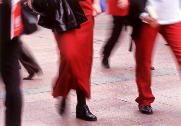 Trendy asian female friends talking while walking in the city.