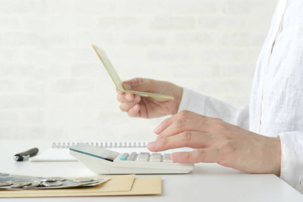 woman keeping household account book - cheep imagens e fotografias de stock