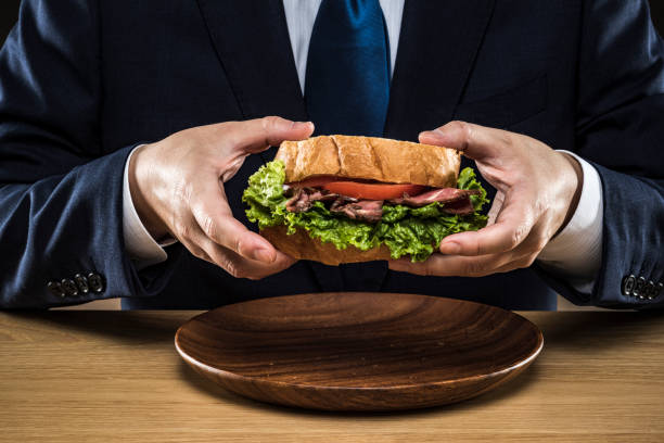 istock Businessman eating a sandwich 1178503773