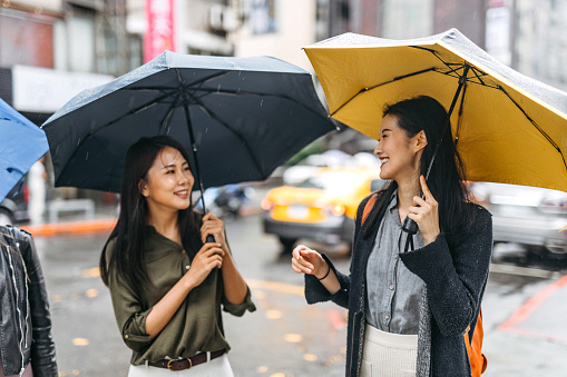 Beautiful Taiwanese women walking down the street on a rainy day