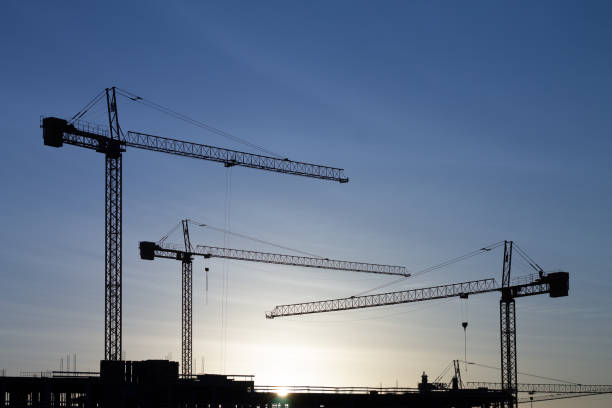 istock group of cranes on construction site at dawn 1178505789