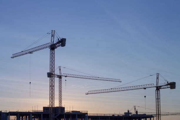 istock group of cranes on construction site at dawn 1178505809