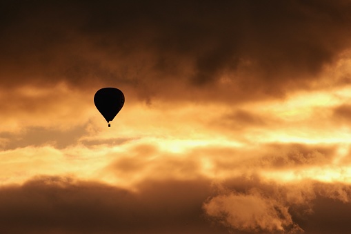 Silhouette of a hot air balloon on the sky within sunset