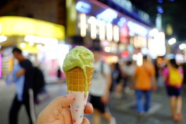 istock A female hand holding a melting green tea ice cream cone 1178508280