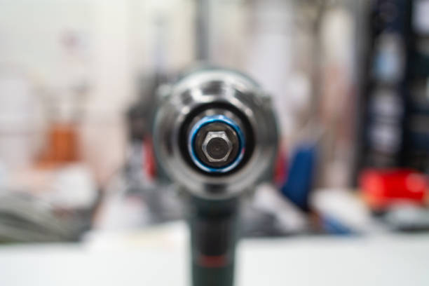 Power tool drill screw head macro close up shot in a lab isolated against bright blurry background 2019