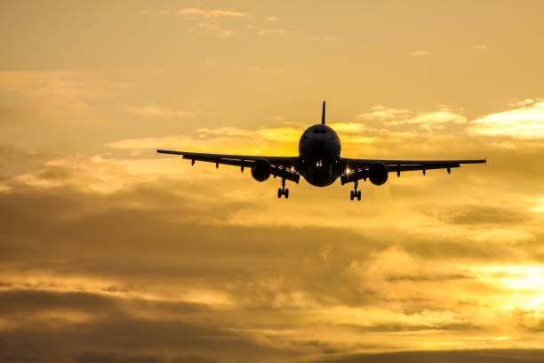 istock air plane in sunset sky 1178511816